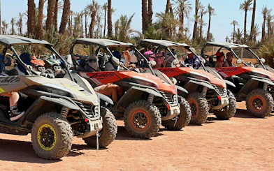 Buggy tour lineup in Marrakech's Palm Oasis with riders preparing for adventure.