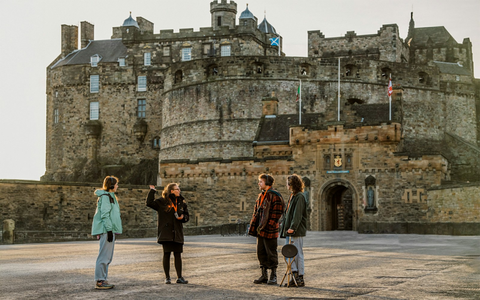 Tour group with guide at Edinburgh Castle entrance on Royal Mile walking tour.