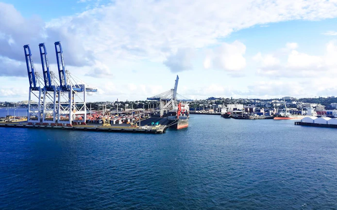 Harbour view with cranes and ships, ideal for a scenic wine and cheese cruise.