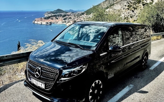 Mercedes E Class parked along the Adriatic coast with Dubrovnik in the background.