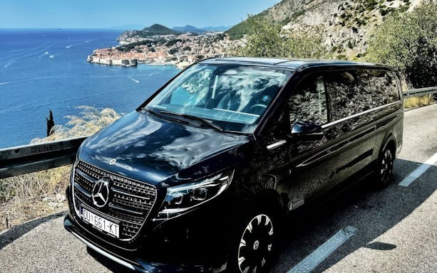 Mercedes E Class parked along the Adriatic coast with Dubrovnik in the background.