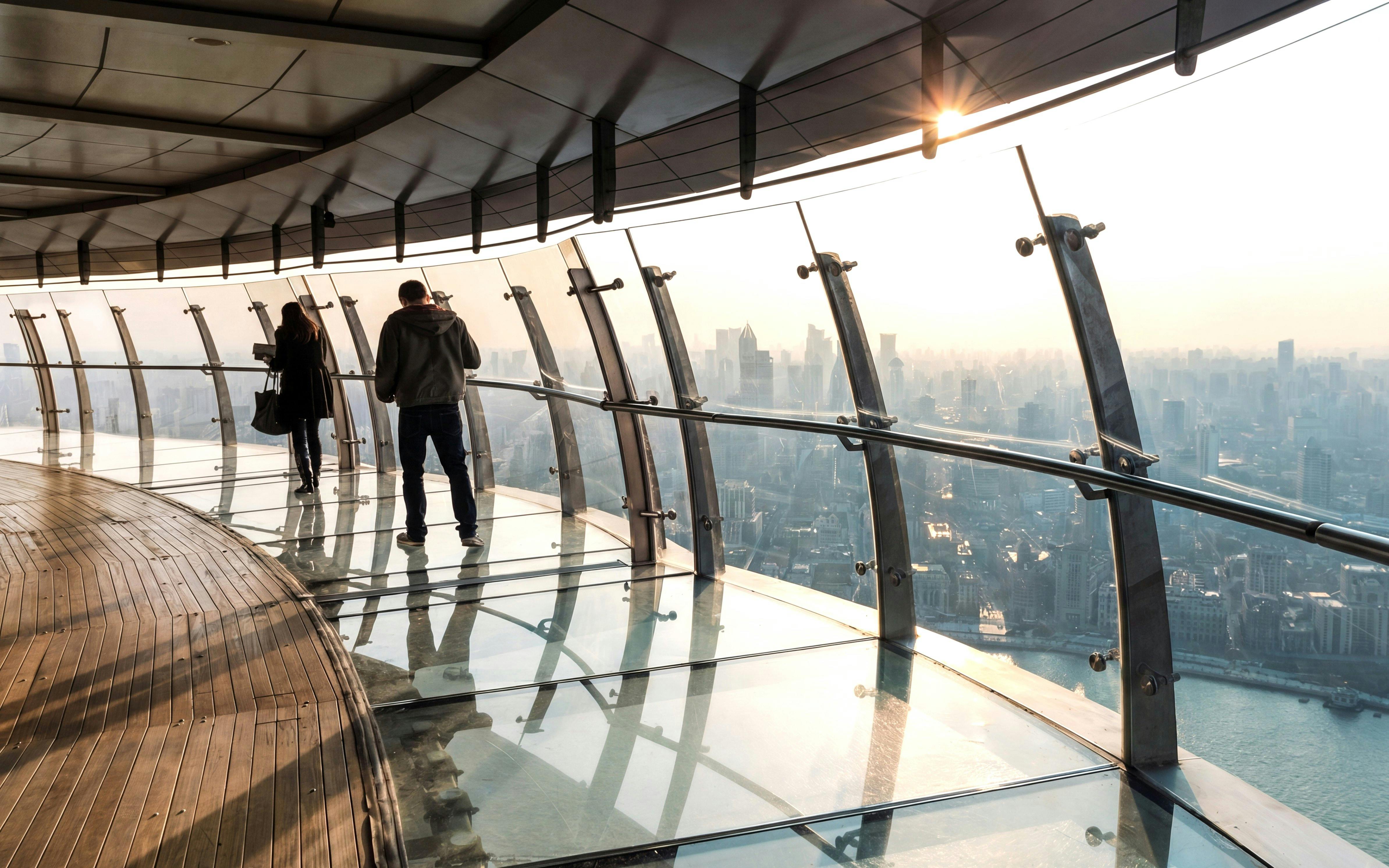 Visitors on the transparent glass observation deck of the Oriental Pearl Tower, Shanghai.