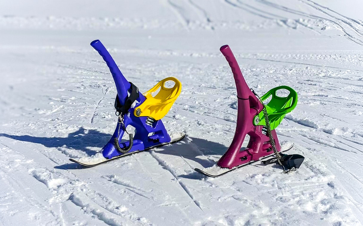 Colorful snow scooters on a snowy landscape in Nagano, Japan.