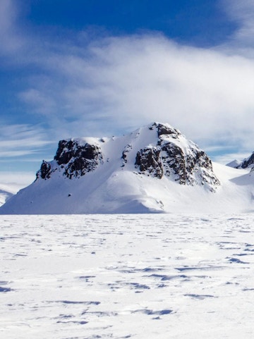 Langjökull Glacier with snow-covered peaks under a clear blue sky in Iceland.