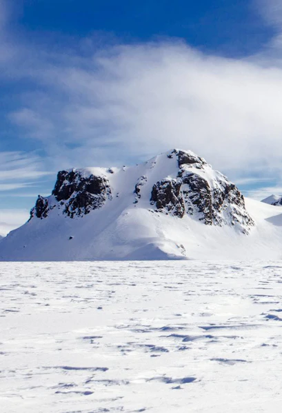 Langjökull Glacier with snow-covered peaks under a clear blue sky in Iceland.