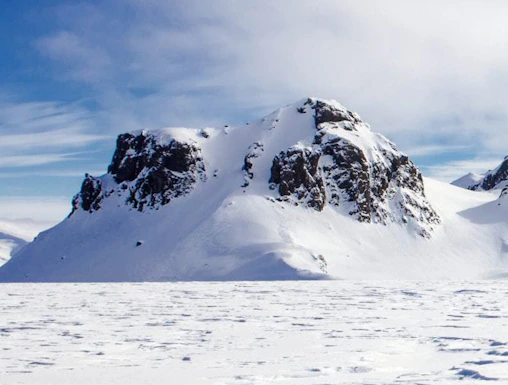Langjökull Glacier with snow-covered peaks under a clear blue sky in Iceland.