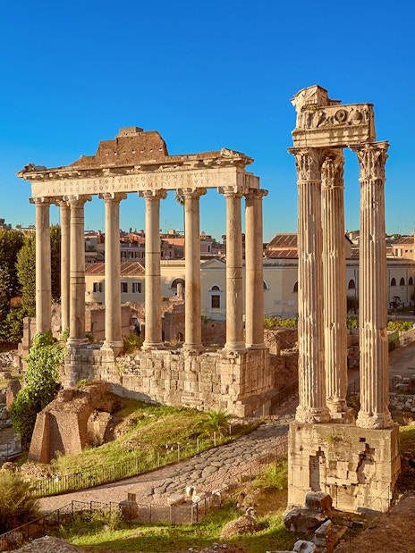 Roman Forum ruins with ancient columns in Rome, Italy.