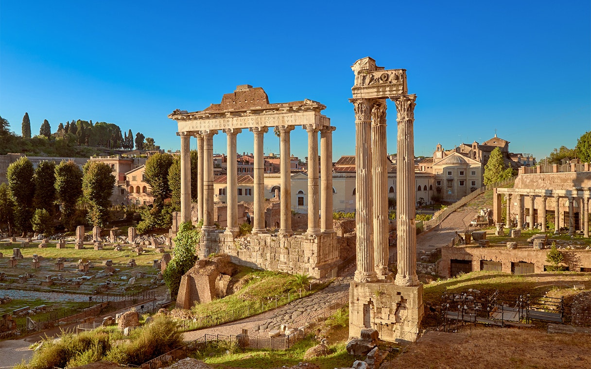 Roman Forum ruins with ancient columns in Rome, Italy.