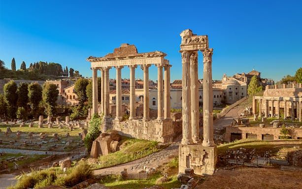 Roman Forum ruins with ancient columns in Rome, Italy.