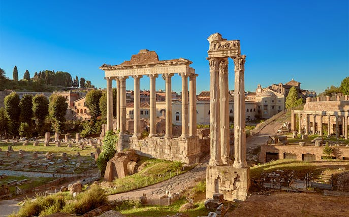 Roman Forum ruins with ancient columns in Rome, Italy.