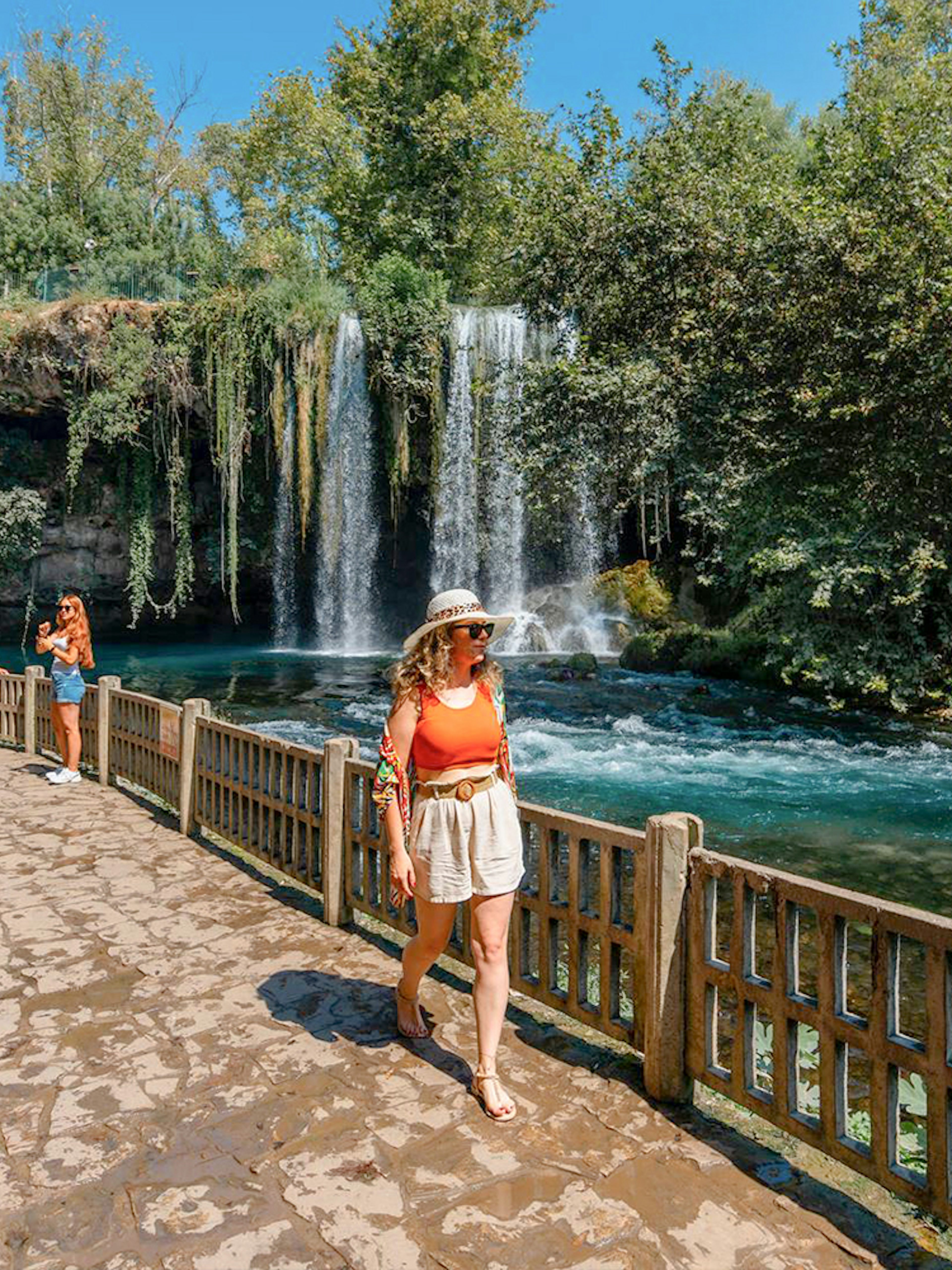 Woman walking by Duden Falls on Antalya sightseeing tour.