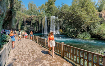 Woman walking by Duden Falls on Antalya sightseeing tour.