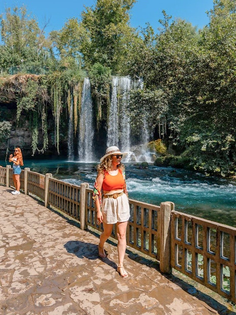 Woman walking by Duden Falls on Antalya sightseeing tour.