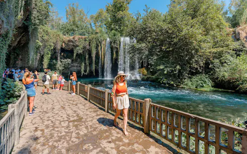 Woman walking by Duden Falls on Antalya sightseeing tour.