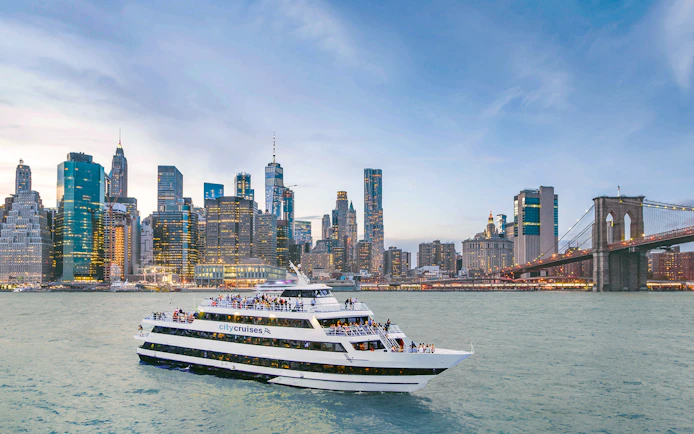 Mimosa brunch cruise at Pier 15 with New York skyline and Brooklyn Bridge.
