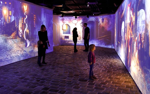 Guests explore immersive Mozart experience with digital projections in Vienna.