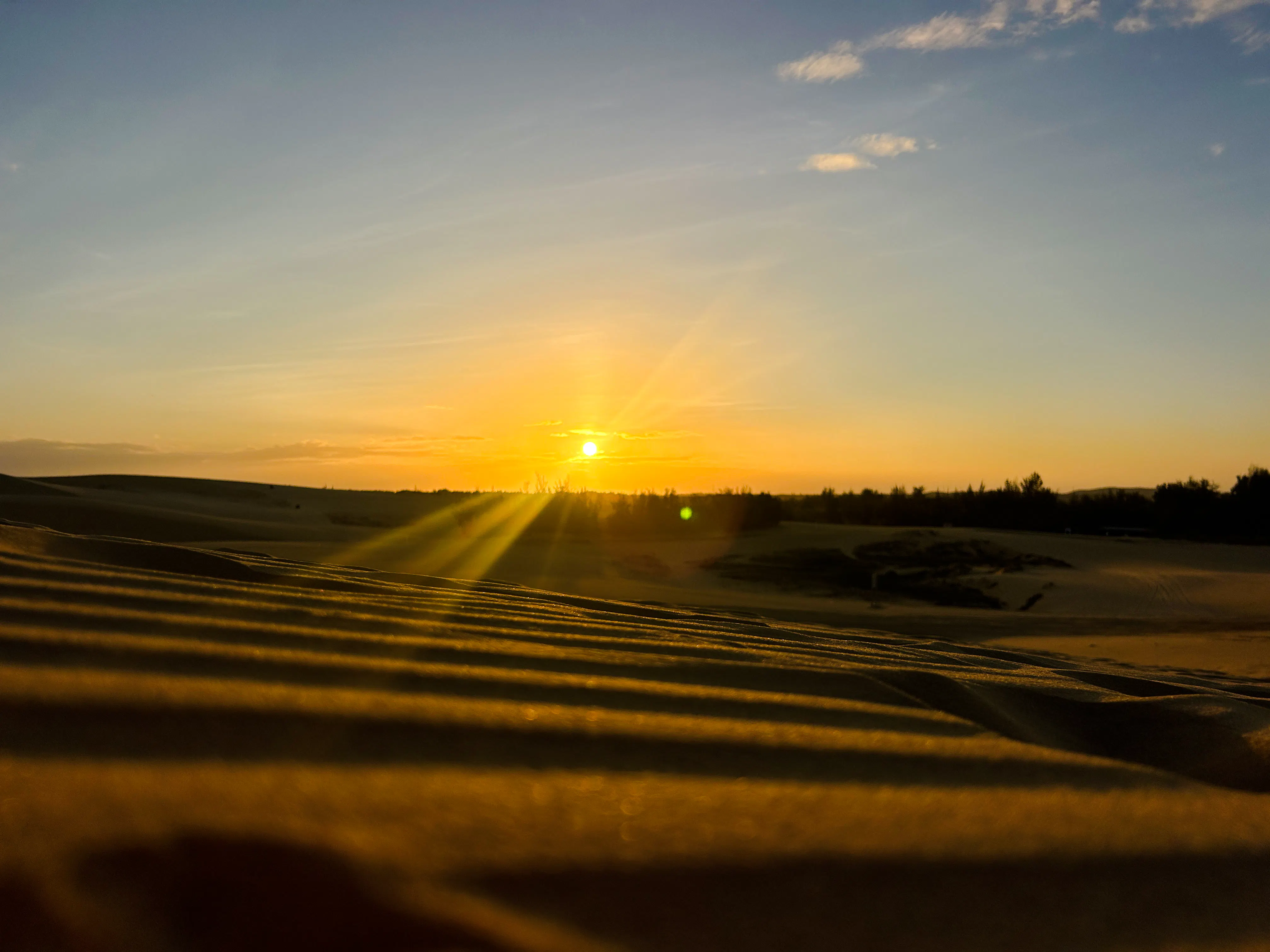 Sunset over sand dunes in Mui Ne during a jeep tour from Ho Chi Minh City.