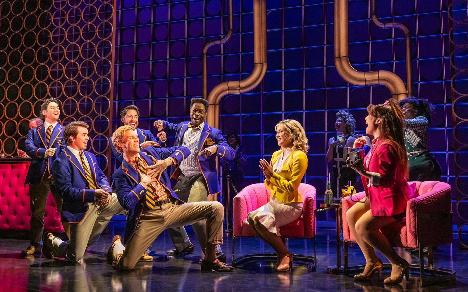 Musical cast performing lively scene in "The Heart of Rock and Roll" show.