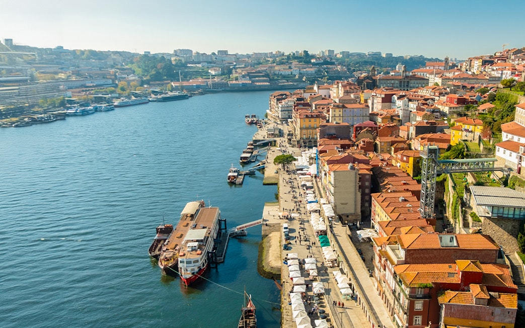 Aerial view of Cais de Gaia with boats docked along the Douro River in Porto, Portugal.