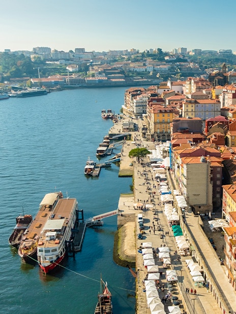 Aerial view of Cais de Gaia with boats docked along the Douro River in Porto, Portugal.