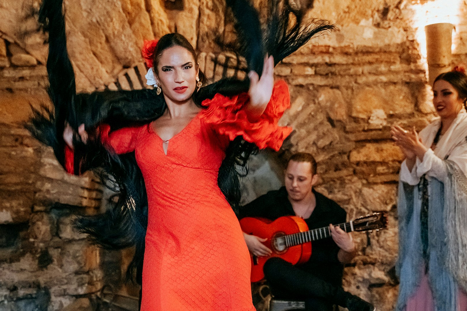 Flamenco dancer performing at Tablao en Baños Árabes de Santa María with guitarist in background.