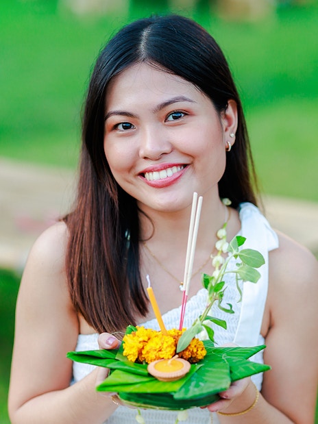Woman holding a krathong at Chiang Mai Sky Lanterns Festival.