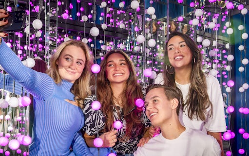 Group enjoying interactive light display at The TUBE exhibit.