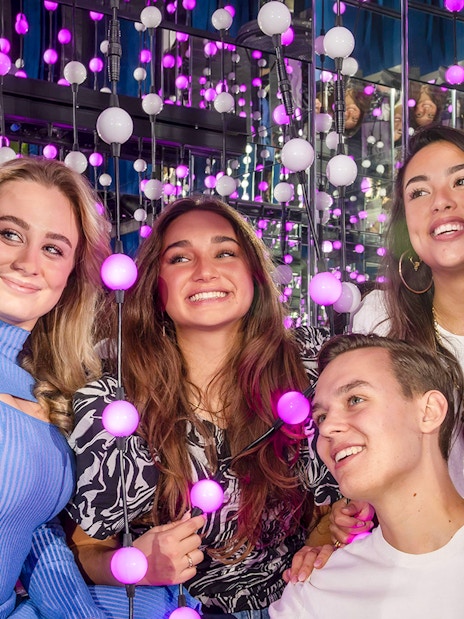 Group enjoying interactive light display at The TUBE exhibit.