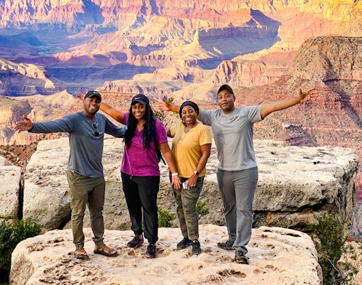 Grand Canyon aerial view with Hummer tour vehicles, part of 140-min Las Vegas to Grand Canyon National Park tour.