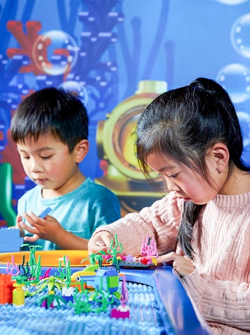 Children building with LEGO bricks at LEGOLAND Discovery Centre, Melbourne.