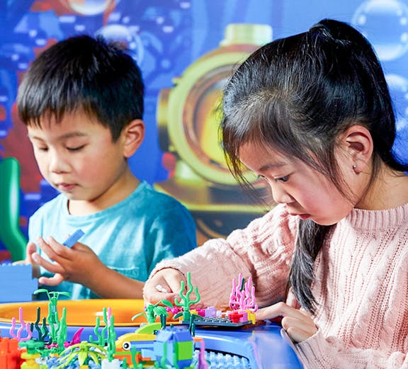 Children building with LEGO bricks at LEGOLAND Discovery Centre, Melbourne.