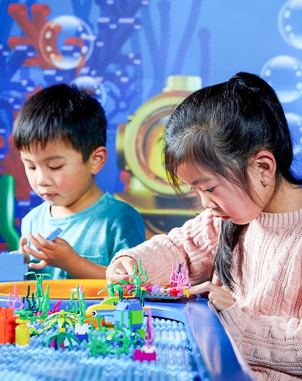 Children building with LEGO bricks at LEGOLAND Discovery Centre, Melbourne.