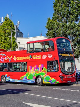 Red double-decker bus for City Sightseeing Galway tour on a sunny street.