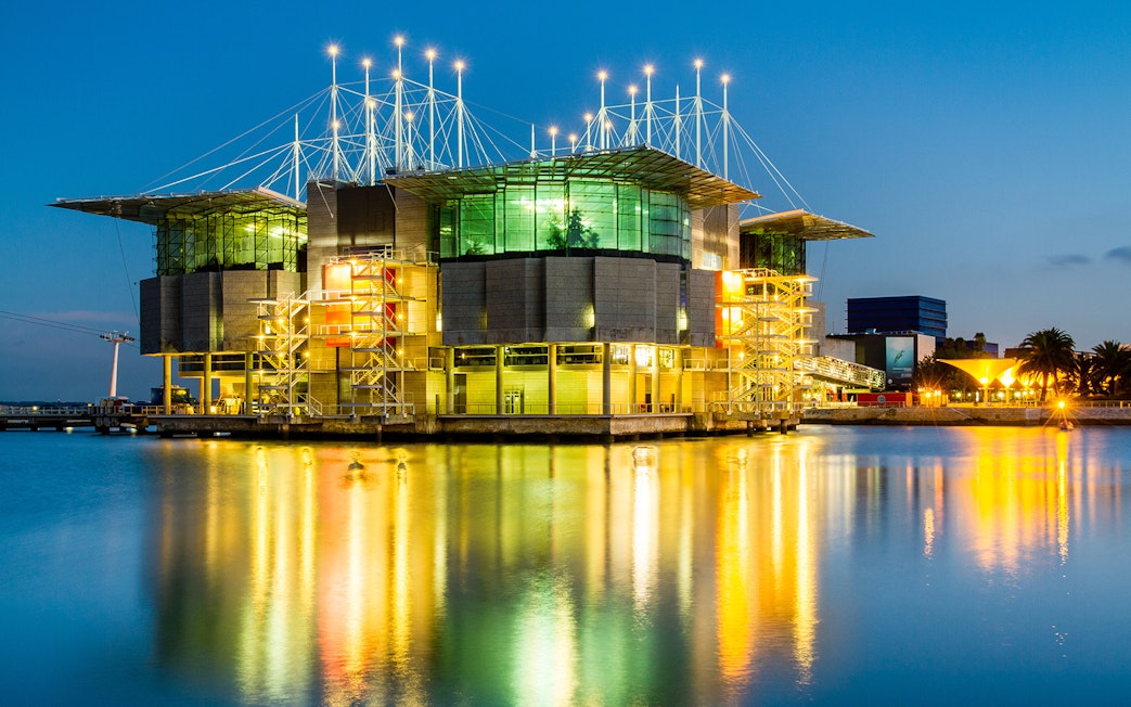 Lisbon Oceanarium illuminated at night, reflecting on the water, Lisbon Card.