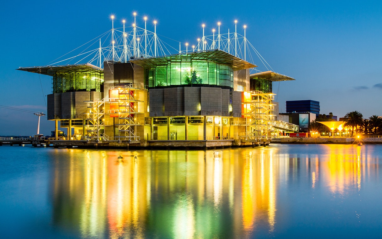 Lisbon Oceanarium illuminated at night, reflecting on the water, Lisbon Card.