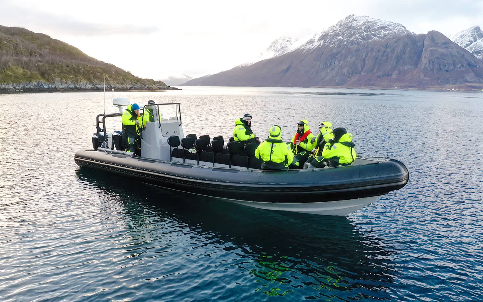 Rib speedboat with passengers on a whale watching cruise in Tromso fjord.