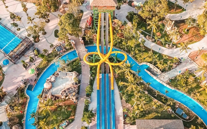 Aerial view of colorful waterslides at Sun World Hon Thom in Phu Quoc, surrounded by lush greenery.