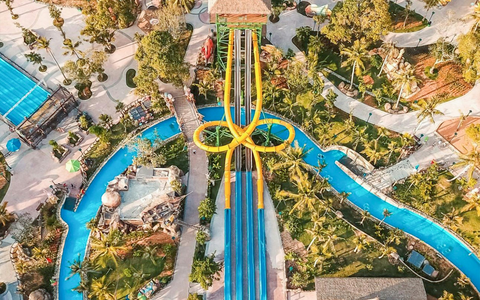 Aerial view of colorful waterslides at Sun World Hon Thom in Phu Quoc, surrounded by lush greenery.