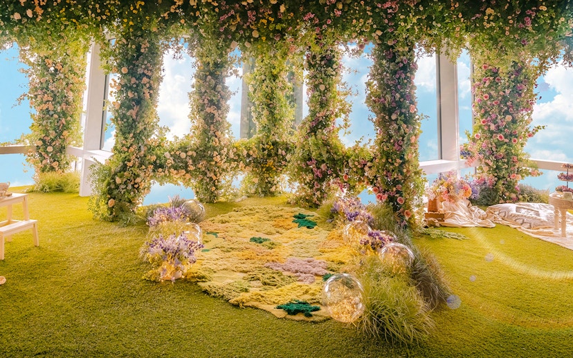 Floral garden display inside Taipei 101 with lush greenery and colorful flowers.