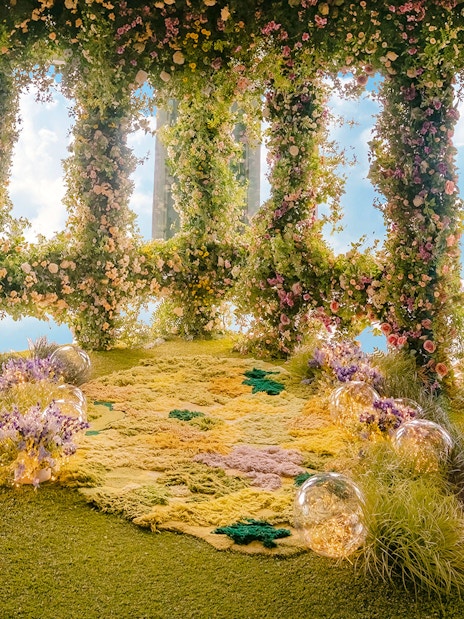 Floral garden display inside Taipei 101 with lush greenery and colorful flowers.
