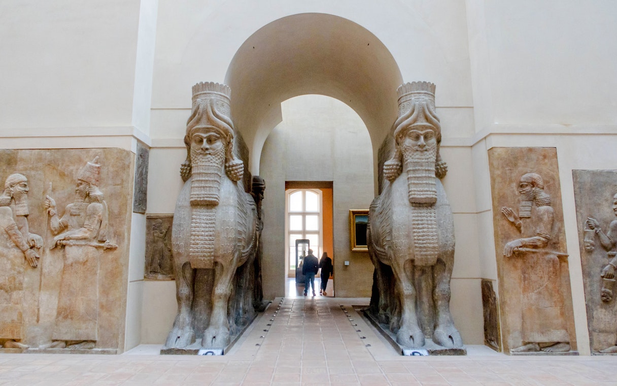 Lamassu statues at Louvre Museum entrance, Paris, France.