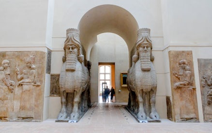 Lamassu statues at Louvre Museum entrance, Paris, France.