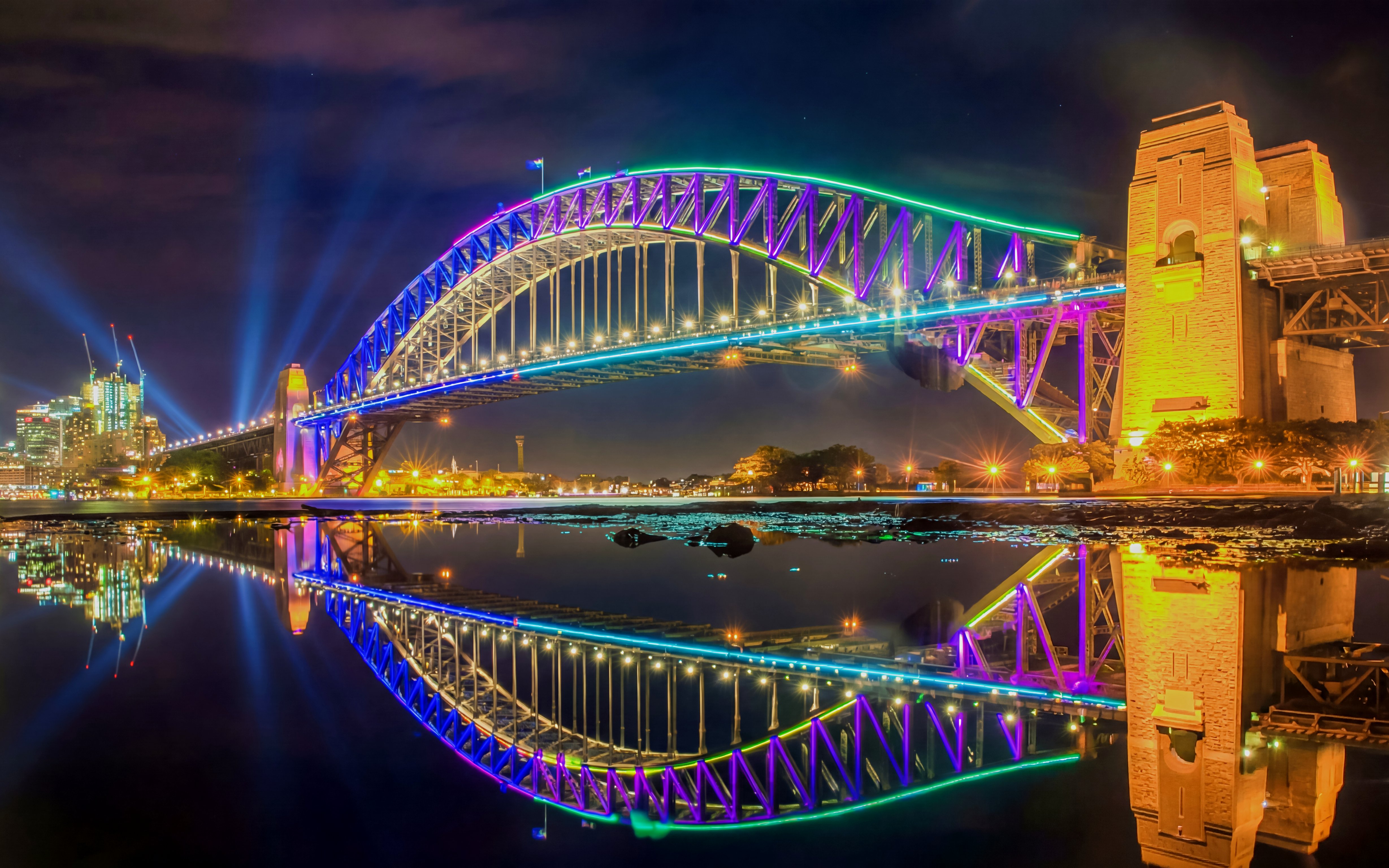 Sydney Harbour Bridge illuminated during Vivid Sydney, viewed from a dinner cruise.