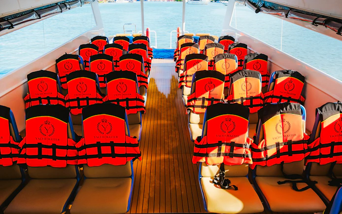 Life jackets on seats inside Premium Speed Catamaran.