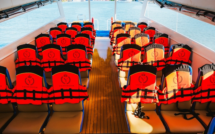 Life jackets on seats inside Premium Speed Catamaran.