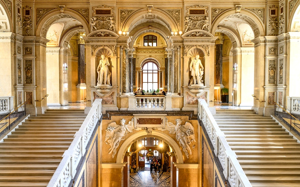 Grand staircase and sculptures inside the Natural History Museum, Vienna.