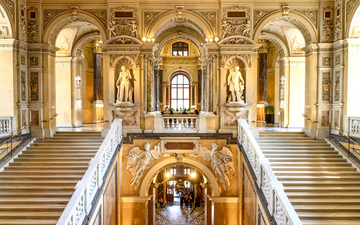 Grand staircase and sculptures inside the Natural History Museum, Vienna.