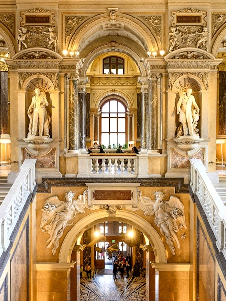 Grand staircase and sculptures inside the Natural History Museum, Vienna.
