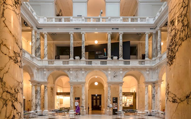 Weltmuseum Vienna interior with marble columns and arches.