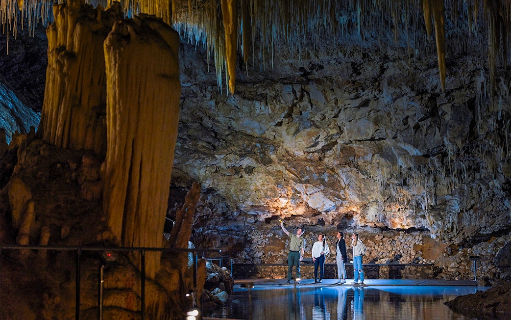 Guide explains cave formations to visitors in Lake Cave, Margaret River.